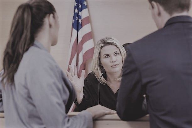 image of judge speaking with attorneys in a courtroom